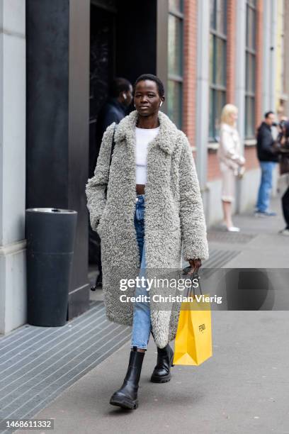 Model is seen wearing teddy fleece coat, denim jeans, white cropped topoutside Fendi during the Milan Fashion Week Womenswear Fall/Winter 2023/2024...