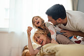 Happy Family In Sleepwear Having Fun Together In The Bedroom
