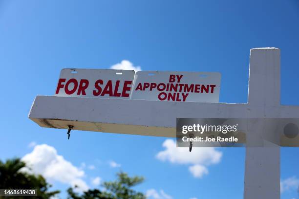 For Sale sign displayed in front of a home on February 22, 2023 in Miami, Florida. US home sales declined in January for the 12th consecutive month...