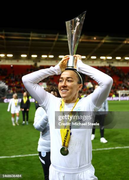 Lucy Bronze of England celebrates with the Arnold Clark Cup trophy after the team's victory during the Arnold Clark Cup match between England and...