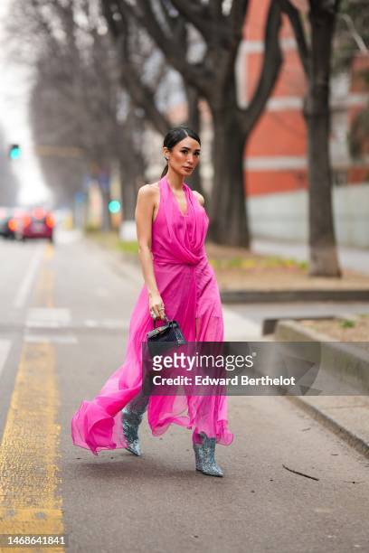 Heart Evangelista wears diamonds earrings, a neon pink backless / halter-neck long silk dress from Alberta Ferretti, diamonds rings, a black shiny...