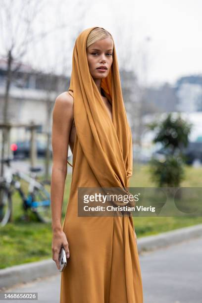 Frida Aasen is seen wearing jumpsuit with head scarf in brown outside Alberta Ferretti during the Milan Fashion Week Womenswear Fall/Winter 2023/2024...