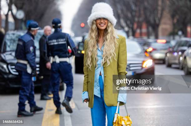 Emili Sindlev is seen wearing white bucket hat, blue pants, khaki blazer, Fendi bag in brown outside Alberta Ferretti during the Milan Fashion Week...