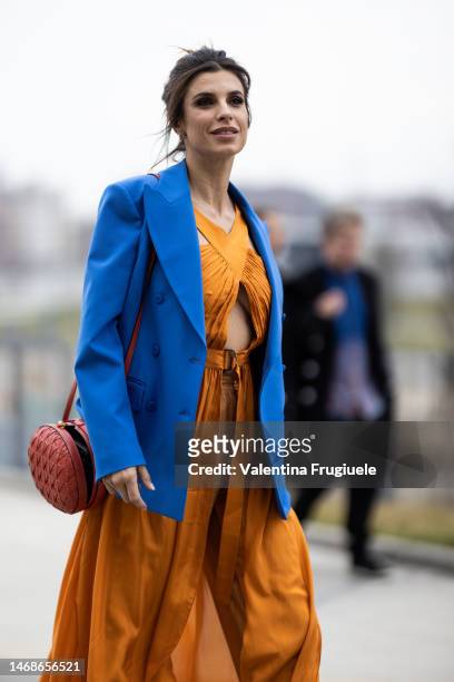 Elisabetta Canalis is seen wearing a sky blue blazer over a slit dress over orange pants outside the Alberta Ferretti show during the Milan Fashion...