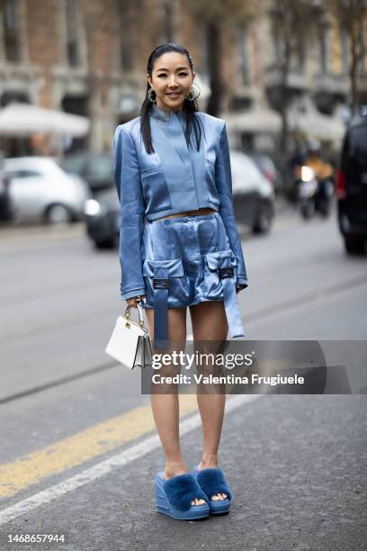 Yuwei Zhangzou is seen wearing an ocean blue cropped silk blazer, silk cargo skirt, furry open sandals and white Peekaboo Fendi bag outside the Fendi...