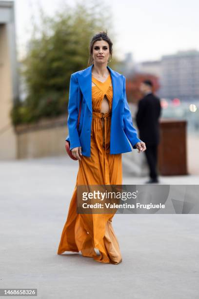 Elisabetta Canalis is seen wearing a sky blue blazer over a slit dress over orange pants outside the Alberta Ferretti show during the Milan Fashion...