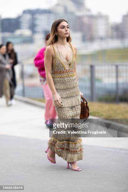 Guest is seen wearing a woven dress over a chiffon dress and pink sandals outside the Alberta Ferretti show during the Milan Fashion Week Womenswear...