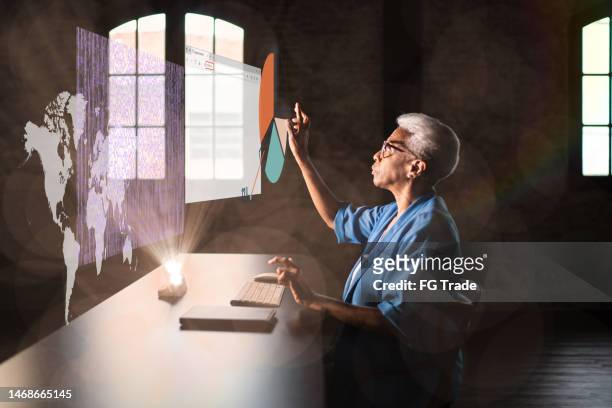senior woman working using an augmented reality device - digital transformation concept bildbanksfoton och bilder