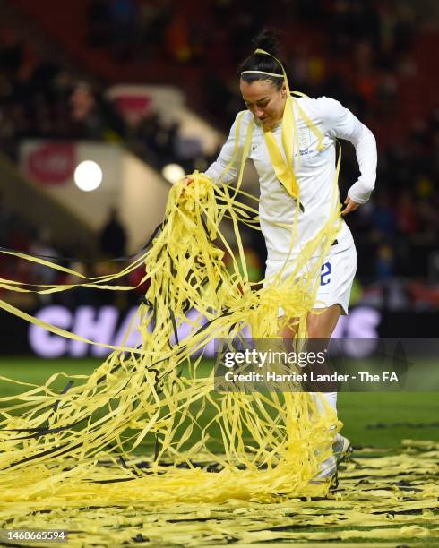 Lucy Bronze of England celebrates with the paper streamers following her team's victory in the Arnold Clark Cup match between England and Belgium at...