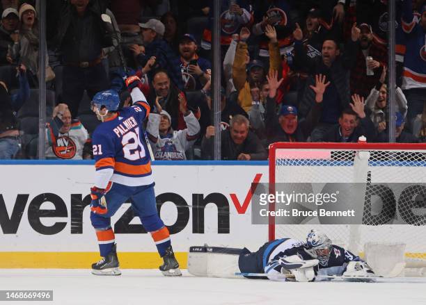Kyle Palmieri of the New York Islanders celebrates a first period goal by Sebastian Aho against Connor Hellebuyck of the Winnipeg Jets at the UBS...