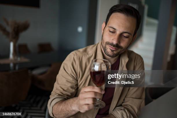 young man drinking wine at home. - men drinking wine stock pictures, royalty-free photos & images