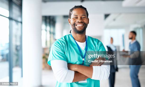 nurse, hospital and portrait of black man in a healthcare, wellness and clinic feeling proud. happy, smile and doctor in a medical facility lobby with happiness from workplace vision and success - doctor looking at camera stock pictures, royalty-free photos & images