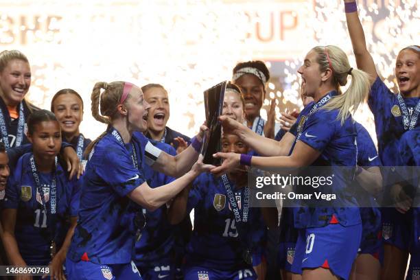 Becky Sauerbrunn and Lindsey Horan of United States lift the trophy to celebrate after winning the 2023 SheBelieves Cup Final against Brazil at...