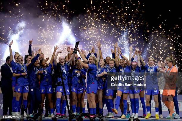 Becky Sauerbrunn and Lindsey Horan of the United States hoist the trophy with their teammates after defeating Brazil in the 2023 SheBelieves Cup...