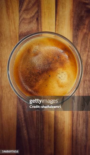 coffee espresso waiting for milk at wood slab - coffee frappe stock-fotos und bilder