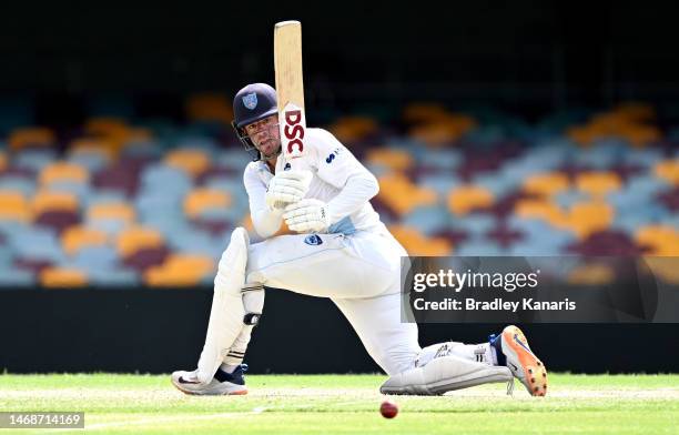 Moises Henriques of New South Wales plays a sweep shot during the Sheffield Shield match between Queensland and New South Wales at The Gabba, on...