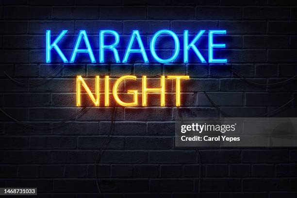 karaoke night text message in neon lights - mike banner stock pictures, royalty-free photos & images