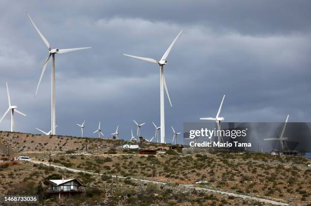 Wind turbines operate at a wind farm near homes on February 22, 2023 near Whitewater, California. Wind turbines in California provide enough energy...