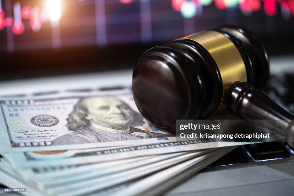 Investment concept,US paper currency on Laptop and gavel,Money with a hammer