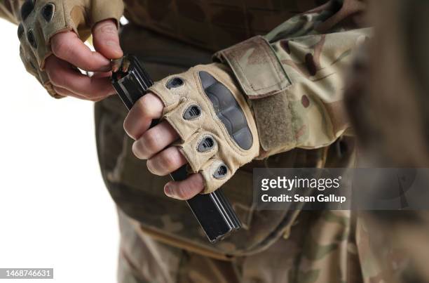 Participant loads bullets into the magazine of an assault rifle during a combat training day hosted by a local paramilitary civil formation called...