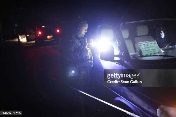 Yaroslav Kryvulya, a reserve officer in the Ukrainian army who leads a local paramilitary civil formation called TSEL, peers into the van of a man...