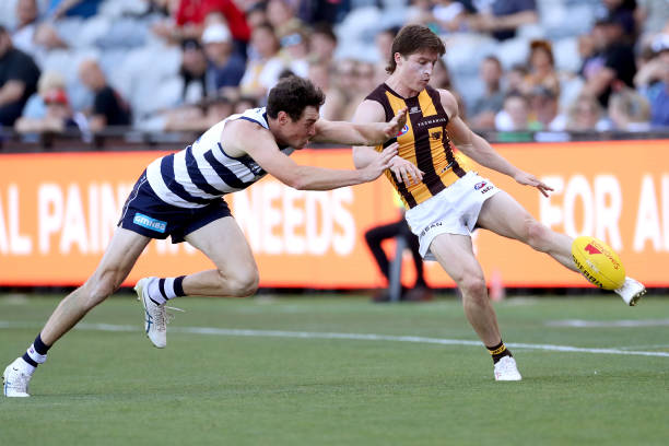 Josh Ward of the Hawks kicks the ball under pressure from Jeremy Cameron of the Cats during the AFL Match Simulation between Geelong Cats and...
