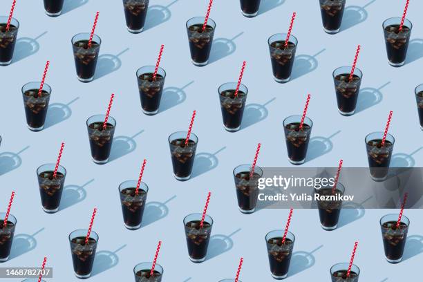 soda drink with red dotted straw on the blue background - pepsi stock pictures, royalty-free photos & images