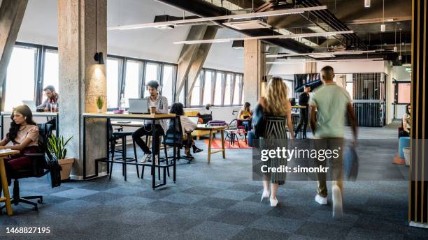 people walking in office - office motion stock pictures, royalty-free photos & images