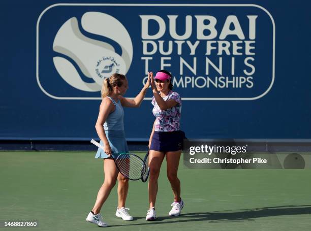 Monica Niculescu of Romania and Kimberley Zimmermann Belgium celebrate scoring a point against Desirae Krawczyk of the USA and Demi Schuurs...