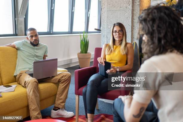 business people talking in office - yellow shirt stock pictures, royalty-free photos & images