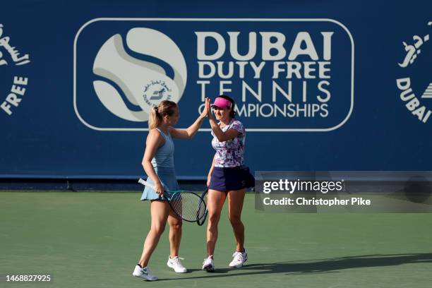 Monica Niculescu of Romania and Kimberley Zimmermann Belgium celebrate scoring a point against Desirae Krawczyk of the USA and Demi Schuurs...