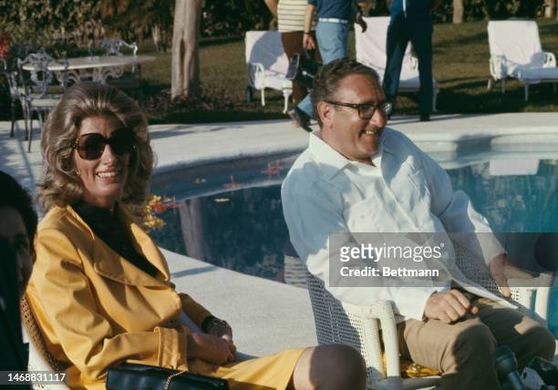Secretary of State Henry Kissinger and his wife Nancy sitting at the poolside during their honeymoon in Acapulco, Mexico, on April 10th, 1974.
