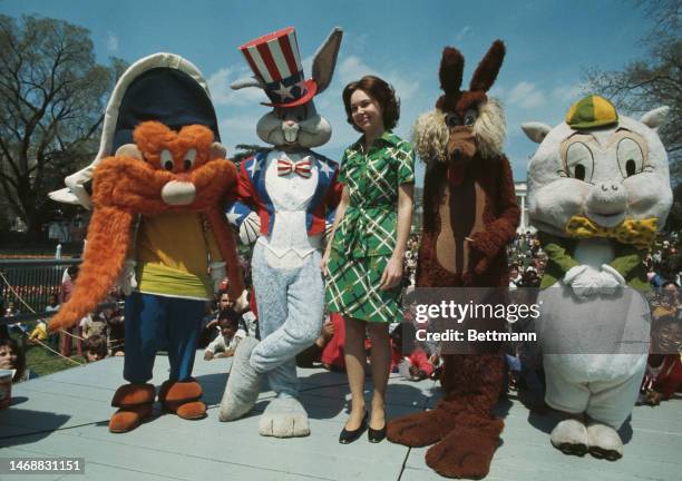 Julie Nixon Eisenhower is joined by a group of Warner Bros cartoon characters at the annual White House Easter Egg Roll in Washington DC on April...