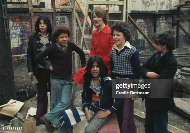British actress Glenda Jackson is joined by a group of children as she poses for photographers in Pimlico, London, the morning after winning a Best...
