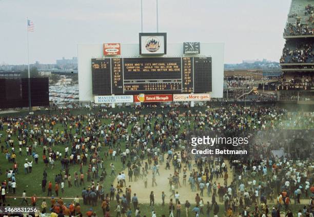Mets fans rush onto the field after the New York Mets' beat the Cincinnati Reds to win the National League title at Shea Stadium in September 1973.