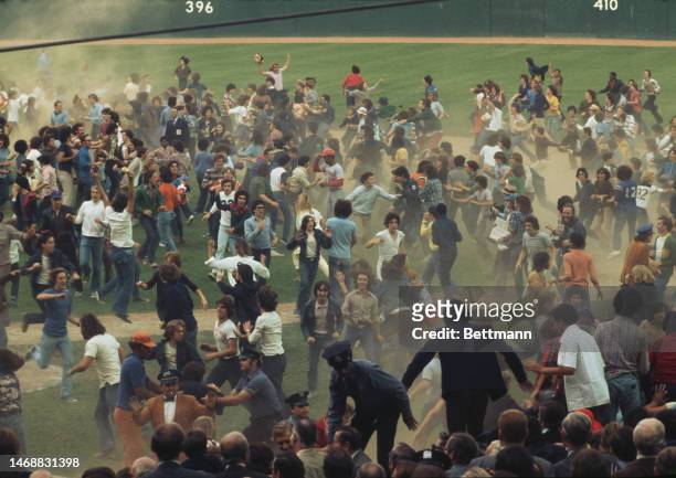 Mets fans rush onto the field after the New York Mets' beat the Cincinnati Reds to win the National League title at Shea Stadium in September 1973.