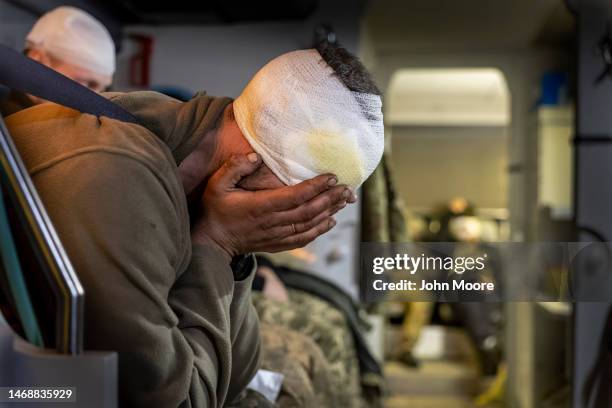 Wounded Ukrainian soldiers are transported from the battlefield on a medical evacuation bus run by Hospitallers on February 21, 2023 in the Donbas...