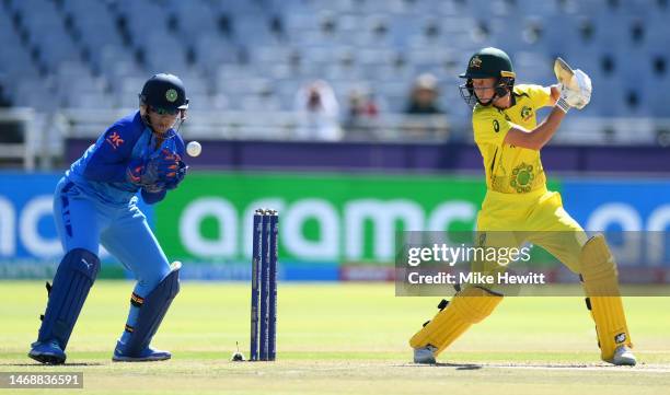 Meg Lanning of Australia plays a shot as Richa Ghosh of India keeps during the ICC Women's T20 World Cup Semi Final match between Australia and India...