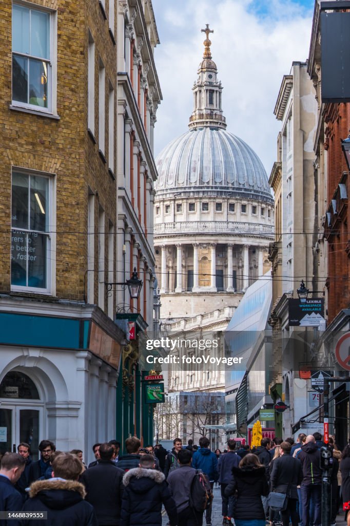 London St Paul's Cathedral overlooking crowded City shopping street pubs