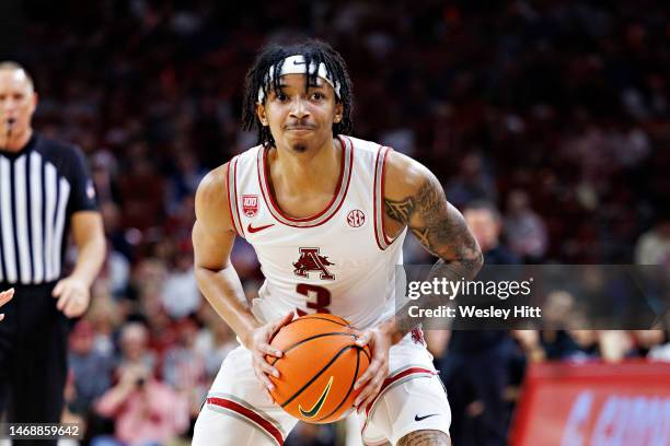 Nick Smith Jr. #3 of the Arkansas Razorbacks looks to make a pass during a game against the Georgia Bulldogs at Bud Walton Arena on February 21, 2023...