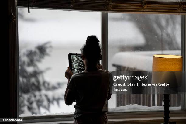 Jalei Haynes takes a picture with her iPad while checking out the snow from her home while distance learning during the multi-day winter snow storm...