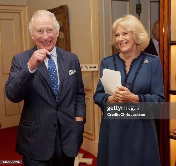 King Charles III and Camilla, Queen Consort laugh during a reception to celebrate the second anniversary of The Reading Room at Clarence House on...