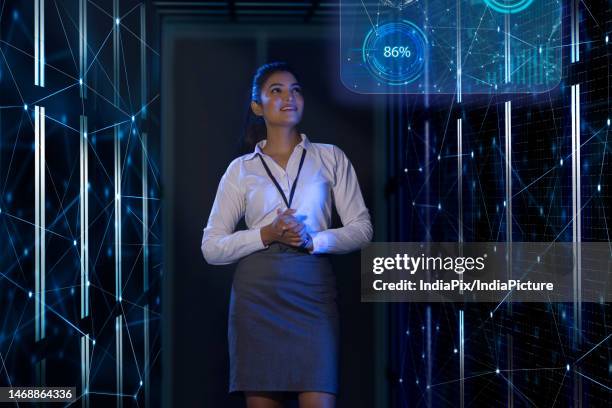 female technician/programmer working on the server in the data storage room - india programmer stock pictures, royalty-free photos & images