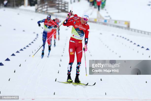 Gold medalist Johannes Hoesflot Klaebo of Norway celebrates as he approaches the finish line to win the Cross-Country Men's Sprint Final Classic at...