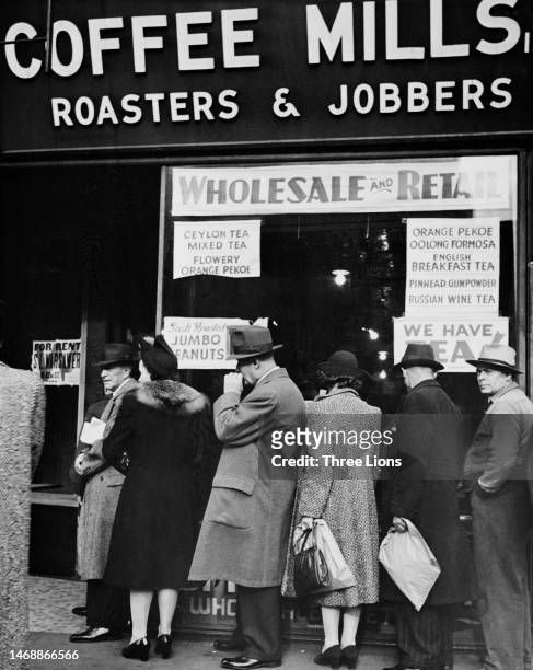 Line of people waiting to buy coffee shortly before coffee joined the list of items rationed, at a store on West 42nd Street in Manhattan, New York...