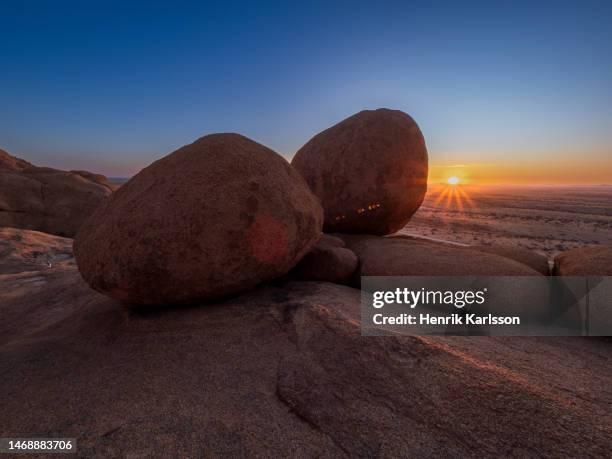 sunrise by rock formations in spitzkoppe area, namib desert, namibia - spitzkoppe stock pictures, royalty-free photos & images