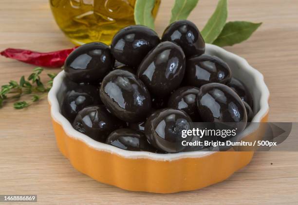 high angle view of olives in bowl on table,vaslui,romania - oliva nera foto e immagini stock