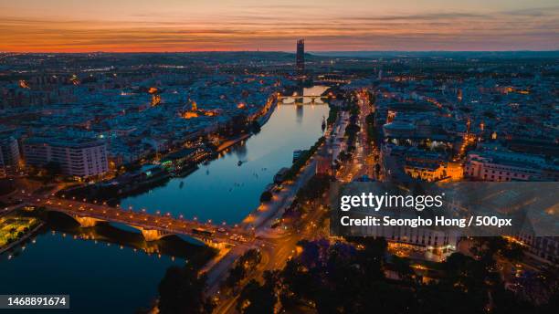 high angle view of illuminated buildings in city at night,seville,spain - sevilha imagens e fotografias de stock