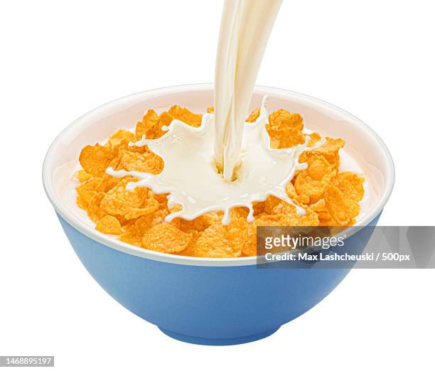 corn flakes with milk splashes isolated on white background - yogurt swirl stock pictures, royalty-free photos & images