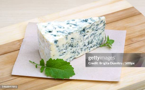 high angle view of cheese on cutting board,vaslui,romania - roquefort cheese stock pictures, royalty-free photos & images
